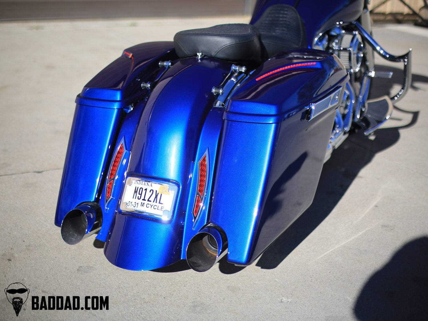 Blue custom saddlebag lids with LED taillights on a Street Glide bagger