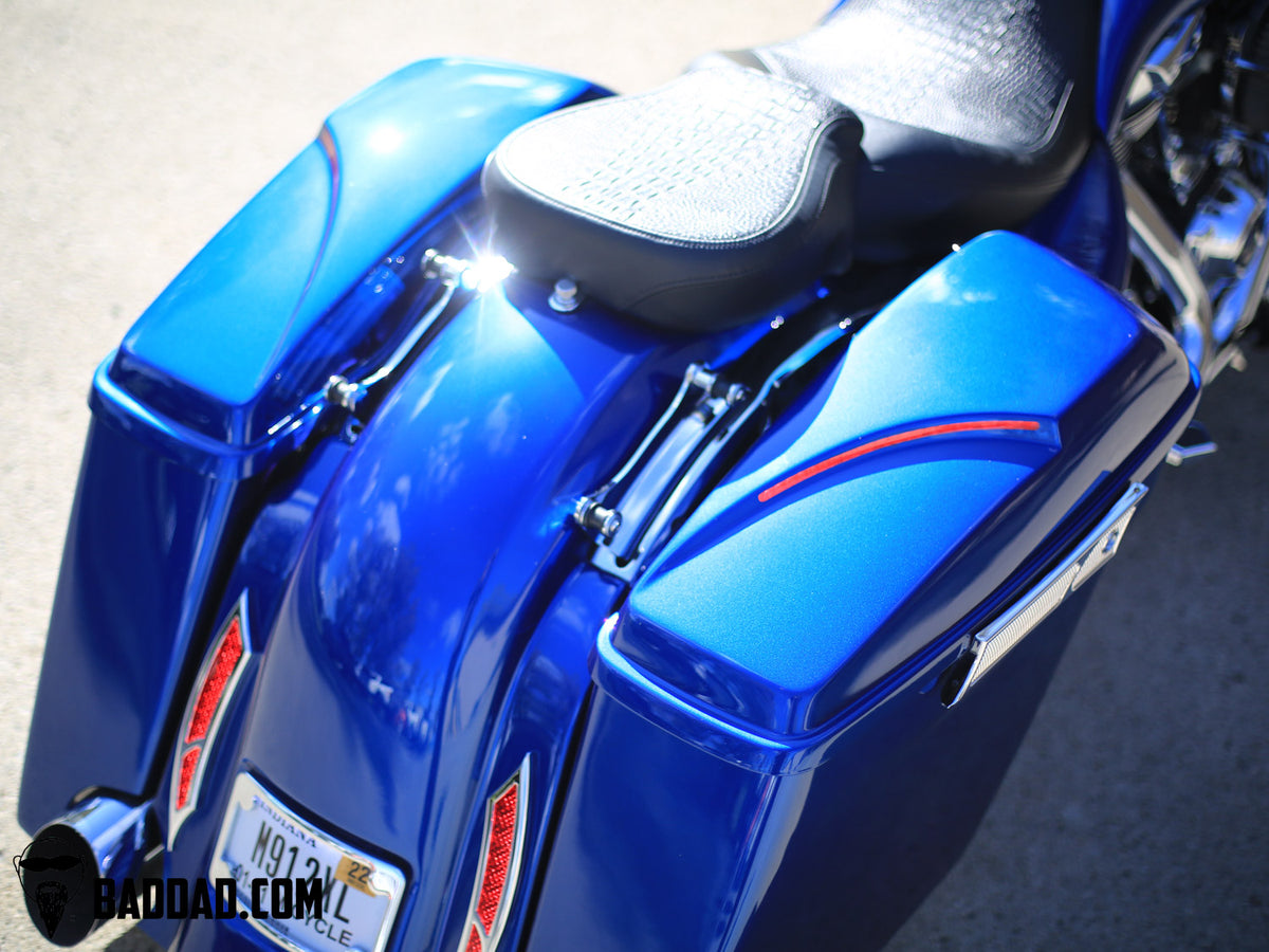 Close-up of blue competition saddlebag lids mounted on a Road Glide