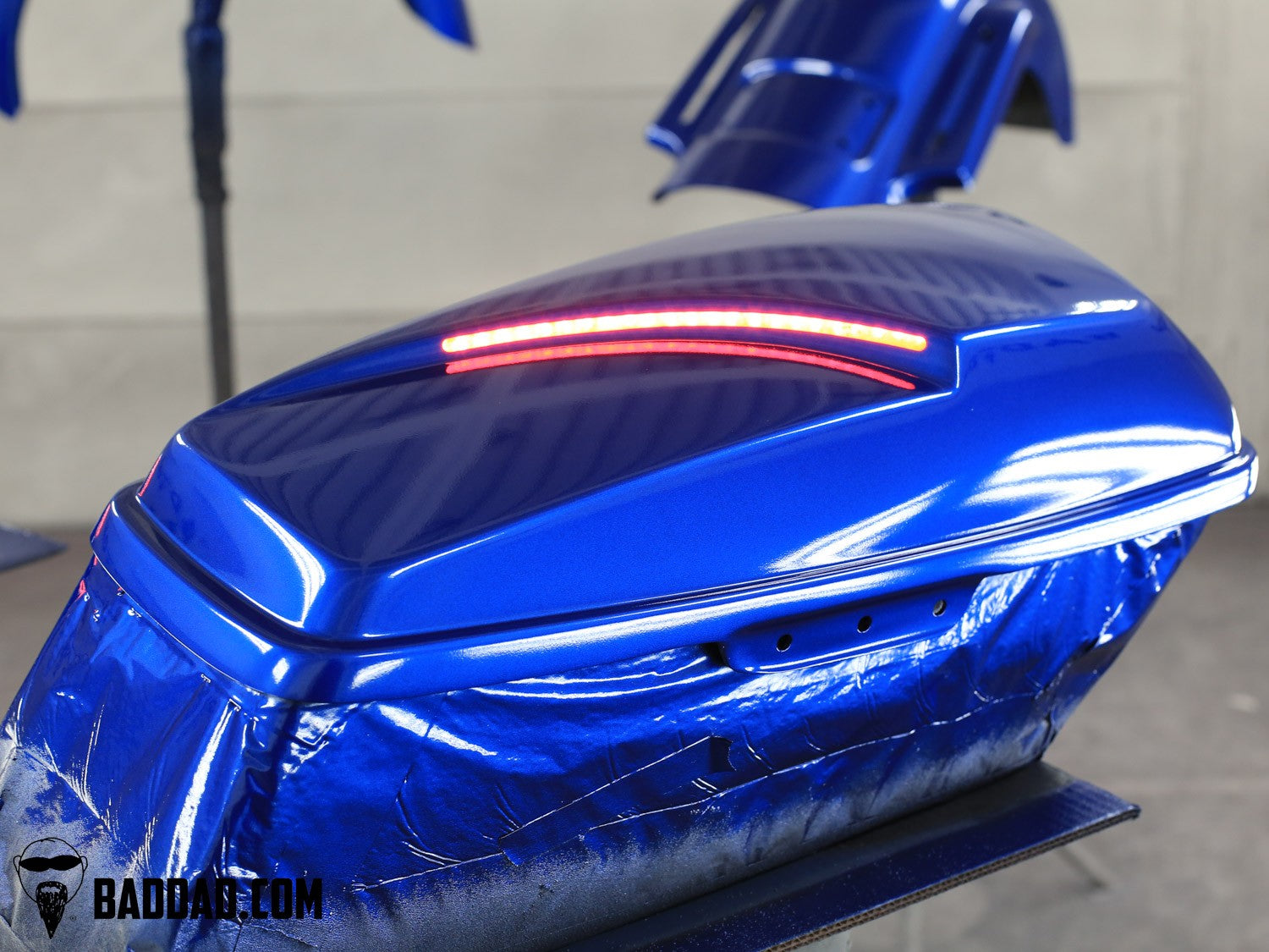 Saddlebag lid with LED taillight on a custom blue Electra Glide