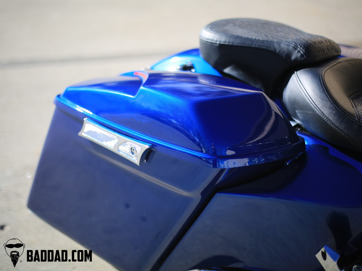 Side view of blue custom saddlebag lid with LED taillight on a Road King