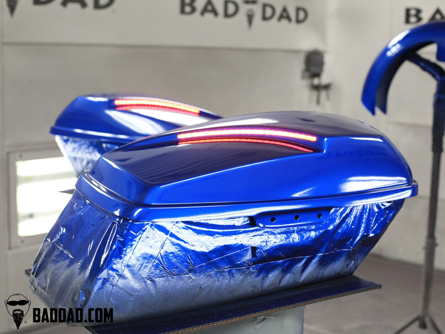 Custom saddlebag lid set in blue paint with LED taillights in the paint booth