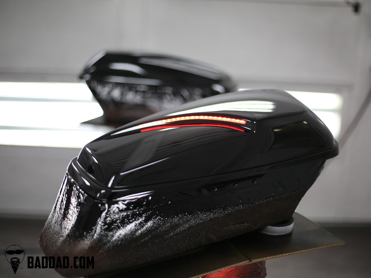 Black custom saddlebag lids with LED taillights, gloss paint finish